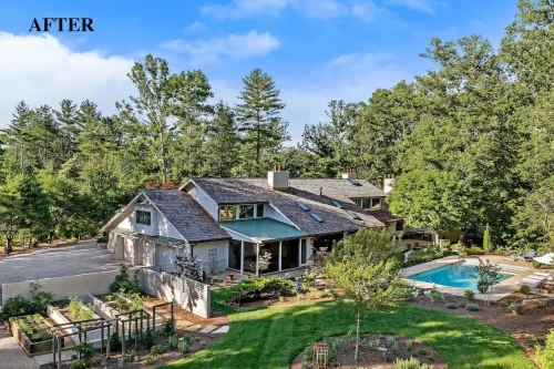 Aerial view of the renovated home featuring light-colored siding, landscaped gardens, a swimming pool, and outdoor living spaces.