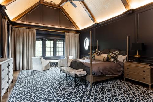 The Phoenix House bedroom with dark walls, and tall ceiling.