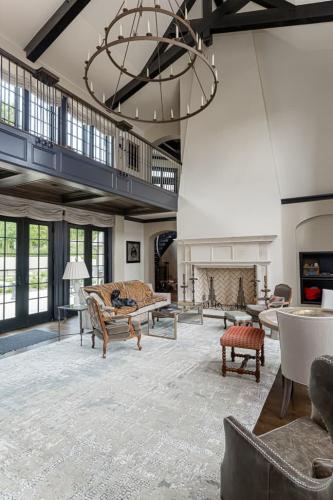 The Phoenix House living room chandelier with very tall ceiling.