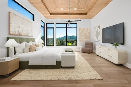 Spacious modern bedroom with vaulted wood ceiling, large windows overlooking the mountains, and minimalist decor.