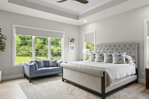 Benton Farms bedroom with white headboard and blue coach.