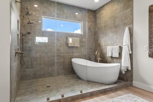 Benton Farms bath with porcelain tub in tiled shower.