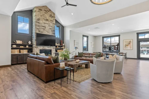 Spacious clubhouse with stone fireplace and modern furnishings