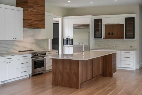Modern kitchen with white cabinetry, a large wood island, stone countertops, stainless steel appliances, and a wood range hood.