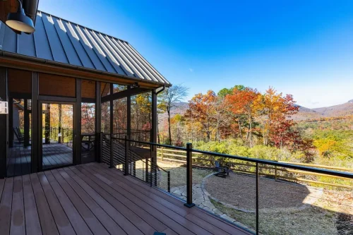 Outdoor deck beside the screened porch overlooking colorful fall foliage and mountain views.