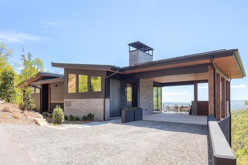 Art House exterior with modern car port and a view.