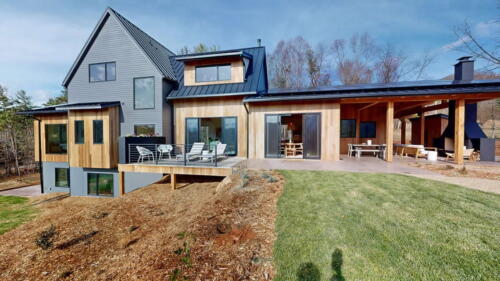 Arcadian Abode back exterior with back deck, and porch.