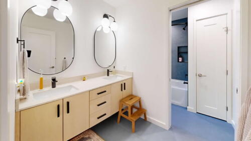 Arcadian Abode bathroom with light wood double sink vanity.