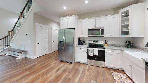 Blue Ridge Modern Farmhouse white kitchen with wood floors.