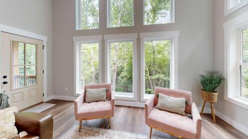 Blue Ridge Modern Farmhouse off white living room with two pink chairs.