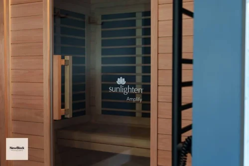 Close-up of Sunlighten sauna logo on glass door.
