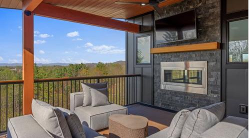 Southern Eclipse house outdoor back deck with built-in fireplace.