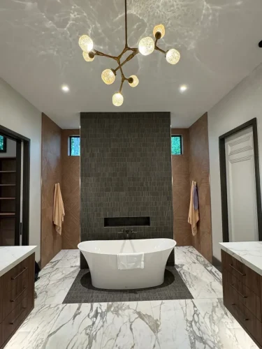 Laundry room with wood cabinetry, front-loading washer and dryer, countertop workspace, and hanging storage.