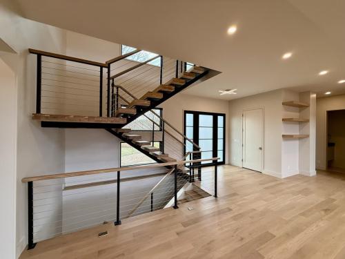The Elie Residence view of stairs going up and stairs going down.