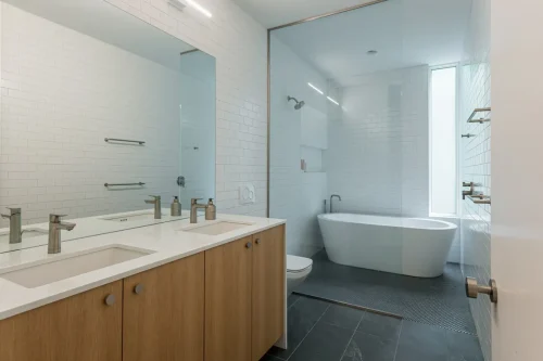 Modern bathroom with soaking tub and double vanity.