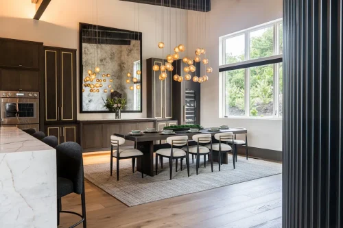 Dining area with large dark wood table, modern chairs, and cluster pendant lights.