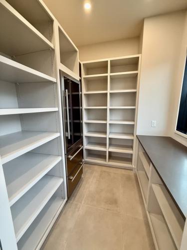The Elie Residence closet with built-in shelves.