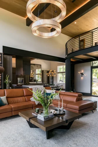 Modern living space with leather sofa, wood coffee table, and view into dining area.