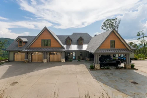 Front view of a large craftsman-style mountain home with a three-car garage.