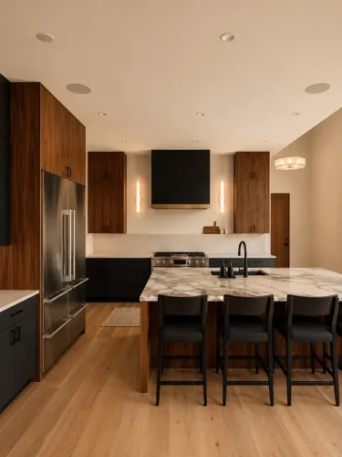 Modern kitchen with walnut cabinetry, dark lower cabinets, a large stone island, and black accents.