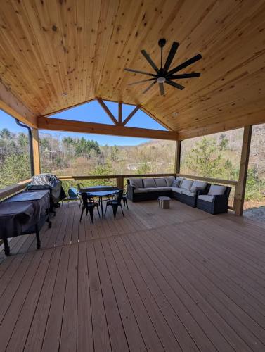 Custom Barndominium back deck with seating and fan.