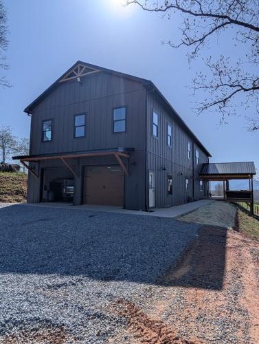 Custom Barndominium back exterior with double garage doors.