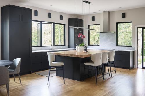 Rockcrest modern kitchen with dark cabinets and wood and dark island.
