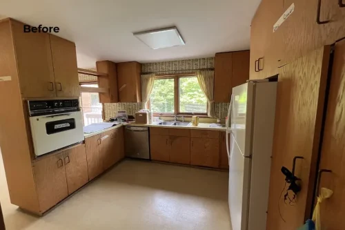 Before renovation kitchen with wood cabinetry, older appliances, and patterned wall covering