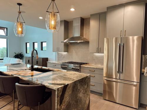 Southern Eclipse house kitchen with tan cabinets, and brown granite island.