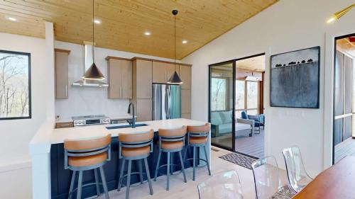 The Modern Tree House kitchen with blue and white island.