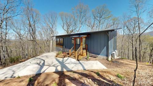 The Modern Tree House exterior front with concrete driveway.