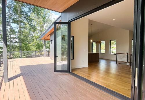 Deck of the Tulip Poplar home; WNC Parade of Homes; Modern Home extra large sliding accordion doors that connects the outside and inside living space.