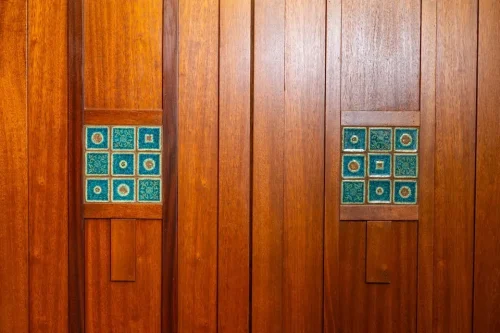 Custom wood paneling featuring inset blue-green decorative tiles.