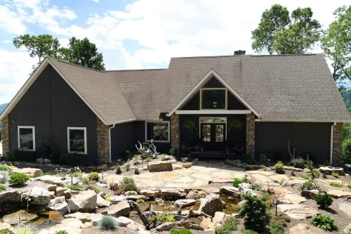 Mountain home exterior with stone accents and landscaped path.