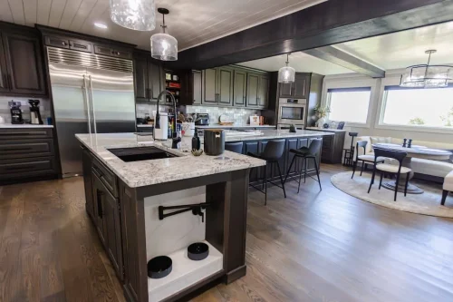 Contemporary kitchen with large island and stainless steel appliances.