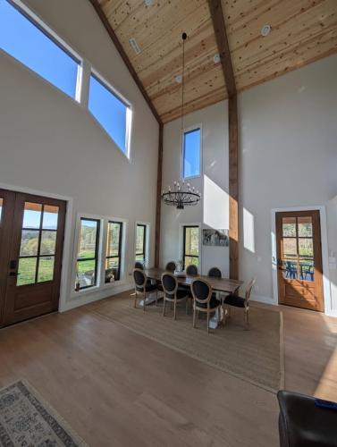 Custom Barndominium dining room with very high ceiling.