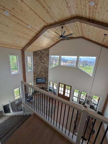 Custom Barndominium view from the loft to the living room.