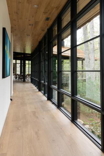 Walnut Valley modern hall with wall of windows.