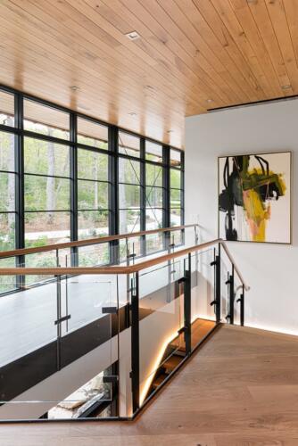 Walnut Valley modern stairs with glass and windows.