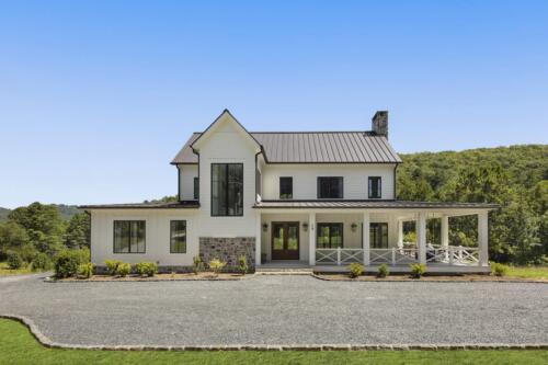 Piney Branch Farmhouse: white house with large porch.