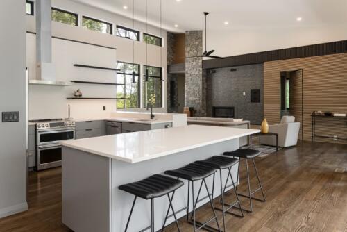 Kitchen with white island and windows.