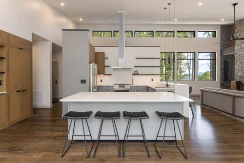 Kitchen with white island and windows.