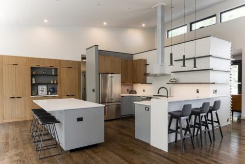Kitchen with white island and windows.
