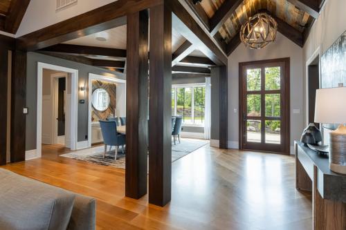 Rustic Mountain Estate entrance with wood beams and dining room table.