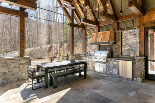 Secluded Sanctuary back porch with kitchen and seating area.